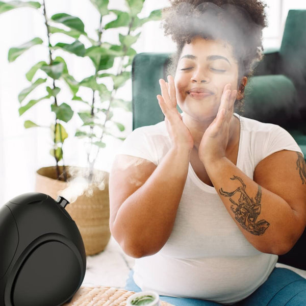 Rivo Facial Steamer  by Fancii & co. in use by a model in Black