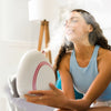 Woman using the Rivo facial steamer for at-home facials All