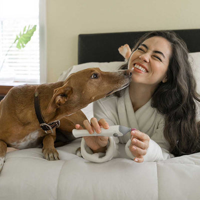 Woman with dog using Mynt electric nail file in Grey