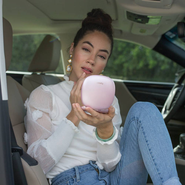 Woman holding Mila lighted compact mirror in Pink