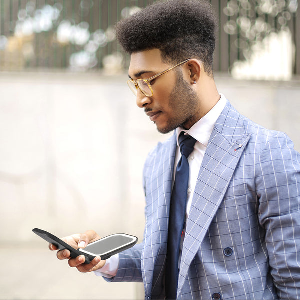 Mica Lighted Compact with built-in powerbank in Black Sesame color by Fancii and Co. A man in a suits casually checks himself out with Mica. 